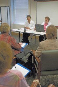 Karen Cooper DO on left guides patients through weight loss techniques at a shared medical appointment Ruth Jerkins RN takes notes on a computer as Dr Cooper speaks with each patient Photo by