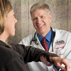 James R ODell FACP examines a patient at the University of Nebraska Cancer risks in patients with rheumatoid arthritis are part of his work-up as is smoking cessation counseling Photo by 