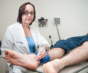 Rebecca J Beyth ACP Member demonstrates the ease and quickness of the ankle-brachial index in diagnosing peripheral artery disease Photo by Eric ZamoraslashUF News Bureau