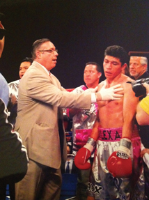 Marc Shaber MD assesses a fighter immediately after a referee stopped a fight in a technical knockout Photo by Ray Bailey