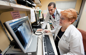 Susan B LeGrand MD FACP seated and Rafael Espinal Bloise MD ACP Associate Member collaborate on patient care at the Cleveland Clinic Incidental findings are sometimes the first signs of hype