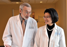 Fred Gill MD FACP chief of the National Institutes of Healths internal medicine consulting service consults with Grace Park MD ACP Member during a break between case studies Photo by Louise Krafft