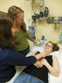 Medical student Wendy Hansen left acquires the parasternal long axis view of the heart during a medical student workshop at Pullman Regional Hospital Janice Boughton MD FACP middle used medica