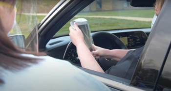 A patient uses a covered iPad to begin her drive-in telehealth visit at Medical Home Primary Care Center in Zanesville Ohio Image by Elliott Cramer